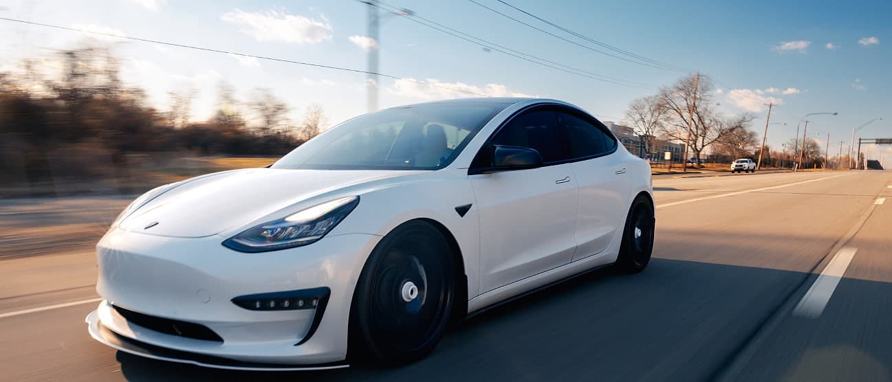 A car at speed on an open road, photographed with a panning blur
