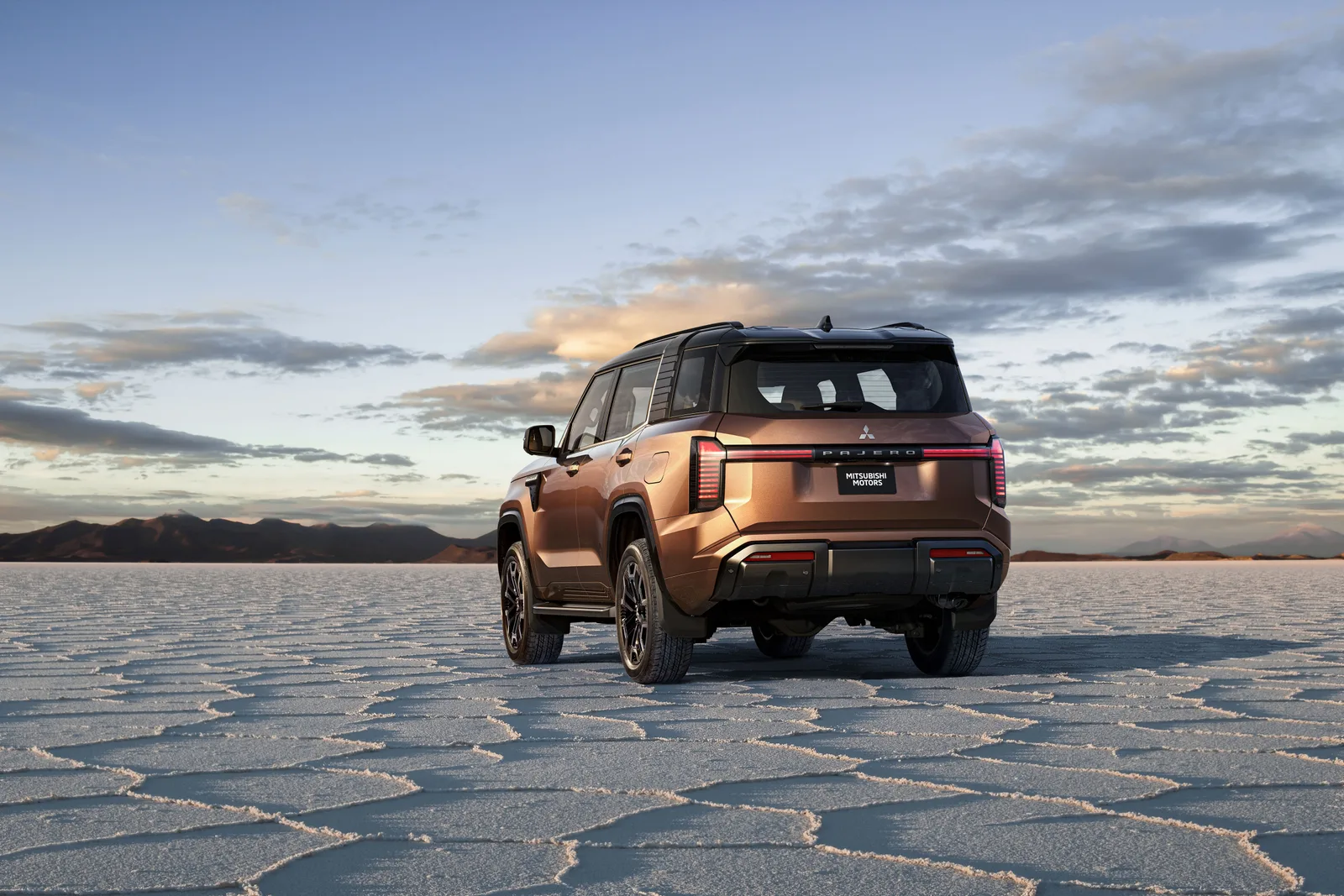 The all-new Mitsubishi Pajero photographed from the rear three-quarter on a salt flat